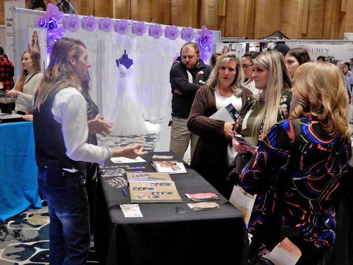 Wedding photographer talking to brides at Wendy's Wedding Expo