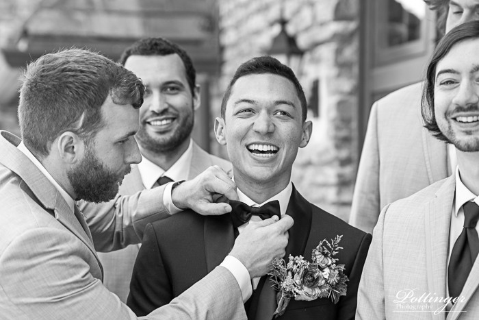 Groomsmen Helping Groom With Bowtie